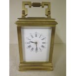 A brass carriage clock with an 8 day movement - Height 17cm - working