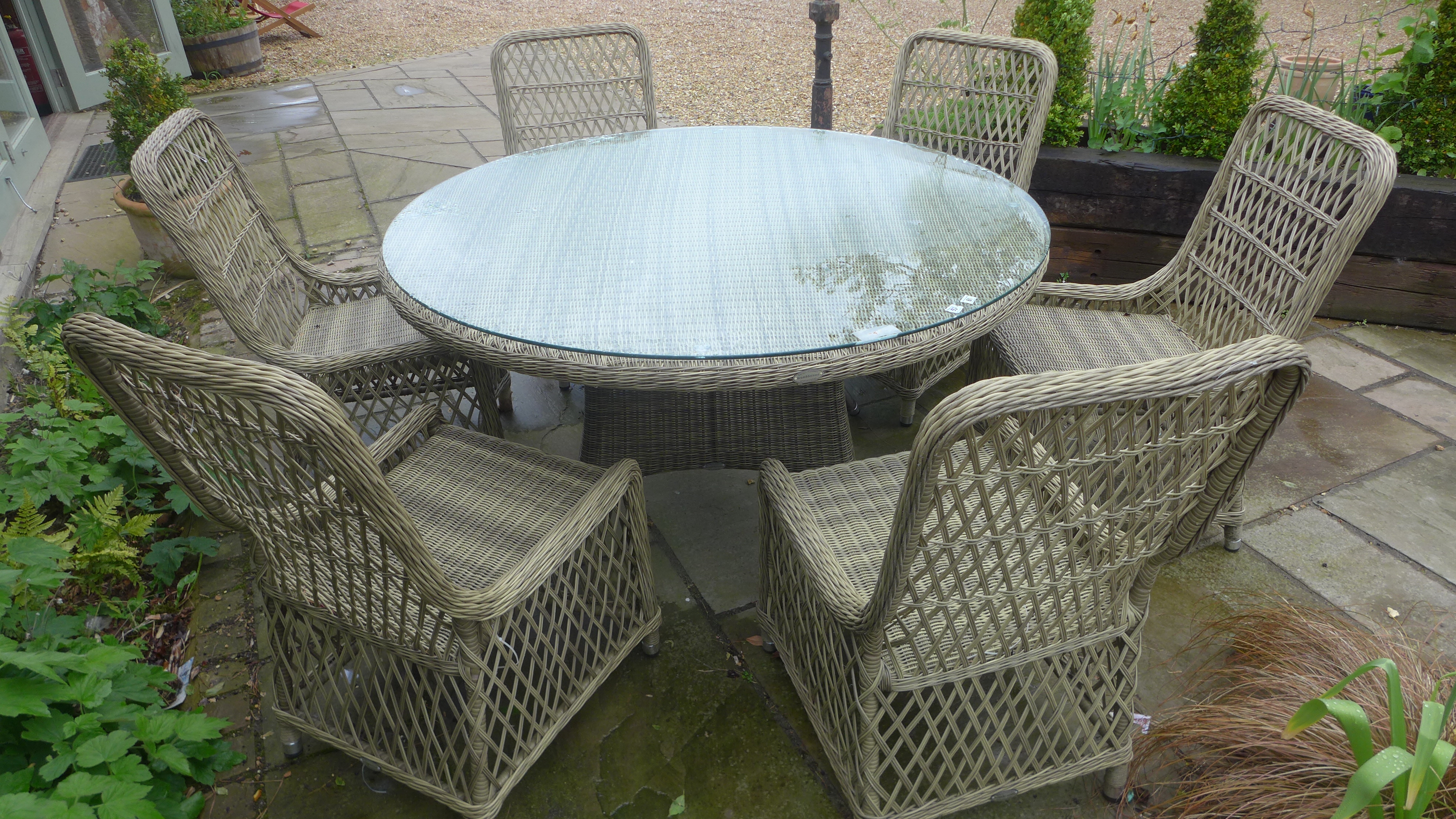 A Bramblecrest Sahara circular table with six rattan chairs - no cushions