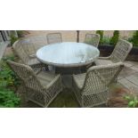 A Bramblecrest Sahara circular table with six rattan chairs - no cushions