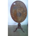 A 19th century walnut tilt top table with a marquetry top and an open twist stem needing