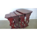 A nest of four red lacquered side table with dragon decoration