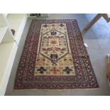 A vintage hand knotted Eastern woolen rug - 190cm x 117cm - general wear,