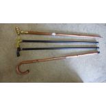 A brass handle walking stick with telescope in handle plus three other walking sticks