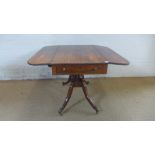 An early 19th century brass mounted rosewood drop flap centre table with opposing frieze drawers on