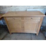 A light oak two drawer two door sideboard matching previous lot - Height 88cm x 121cm x 47cm in