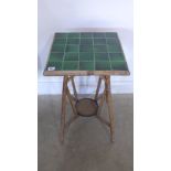 A bamboo table with green tiled top