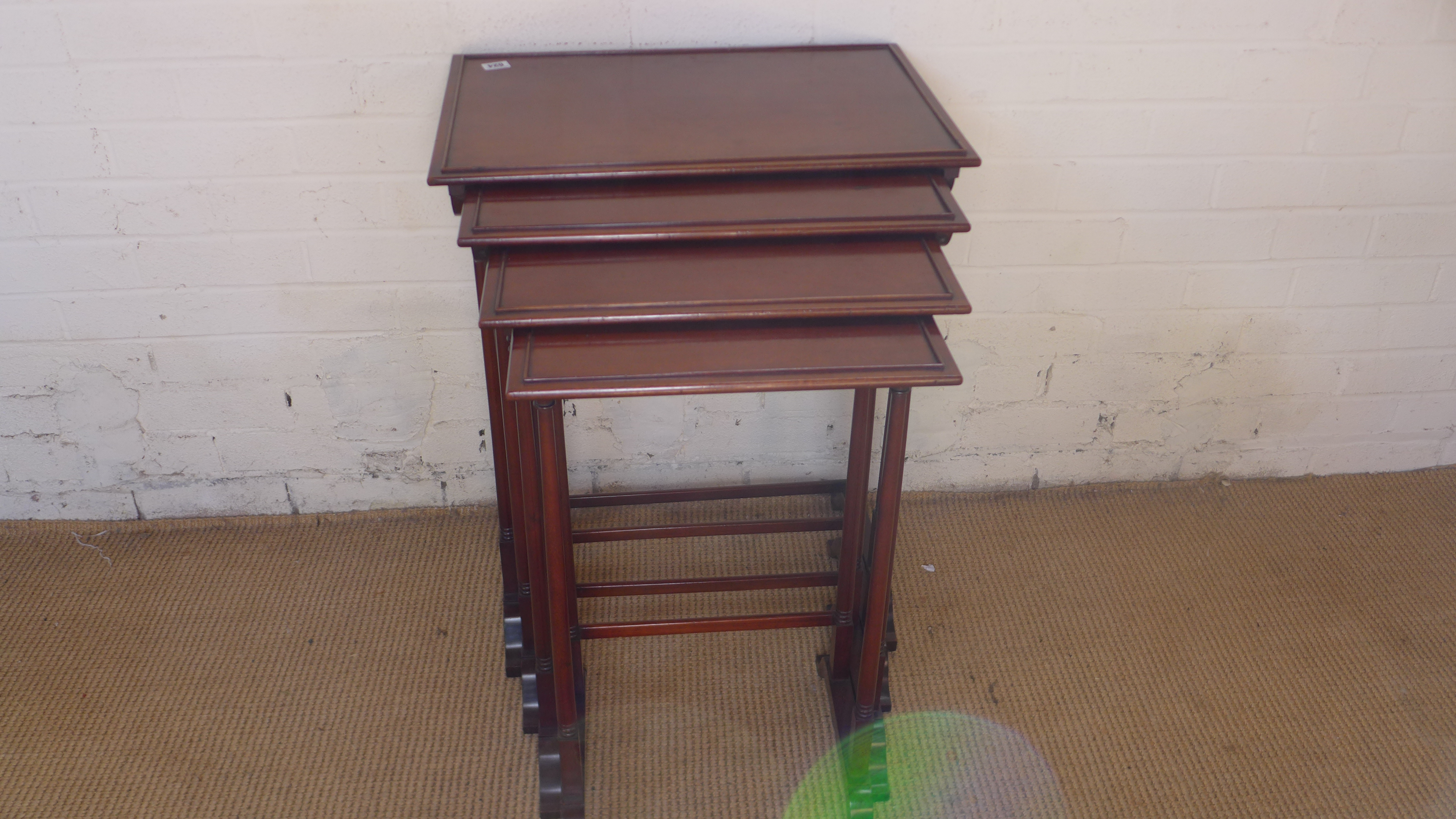 A late 19th/20th century mahogany nest of four tables on turned supports