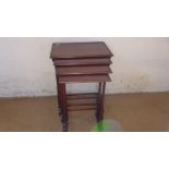 A late 19th/20th century mahogany nest of four tables on turned supports