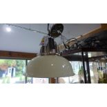 A new Culinary Concepts hanging industrial style light fitting in chrome with a cream shade -