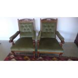 A pair of late Victorian carved walnut open armchairs with buttoned backs