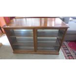 A Victorian style mahogany shop counter with shallow two door display to front and cupboards to