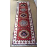A Kazak 100% wool hand knotted rug - 250cm x 81cm
