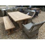 A Bramblecrest Kuta teak table with a bench and four chairs