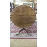 A Georgian oak side table with a tilt top on a tripod base - Height 72cm x Diameter 90cm