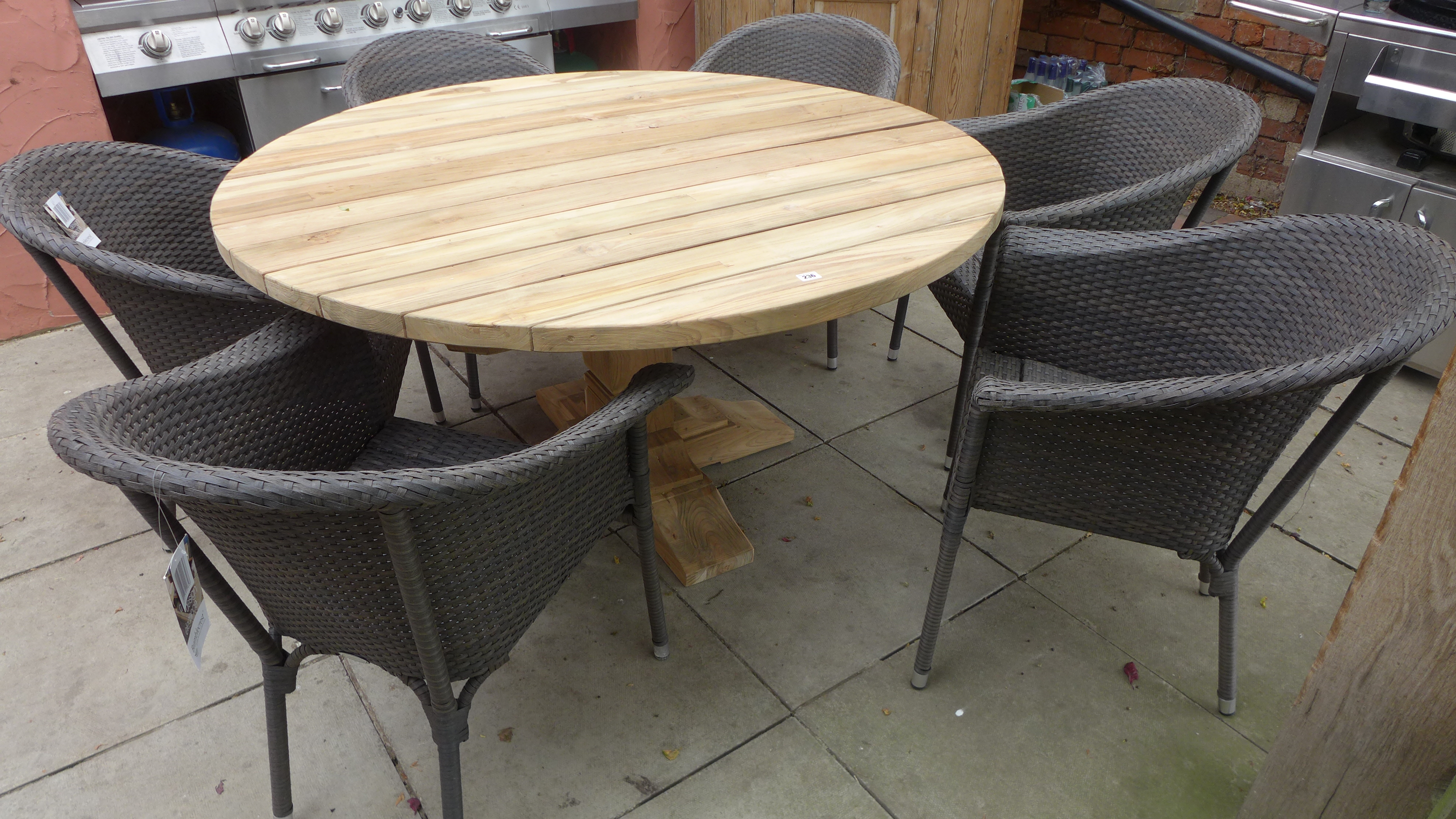 A Bramblecrest Kuta teak dining table - 180cm x 100cm and six Rio armchairs