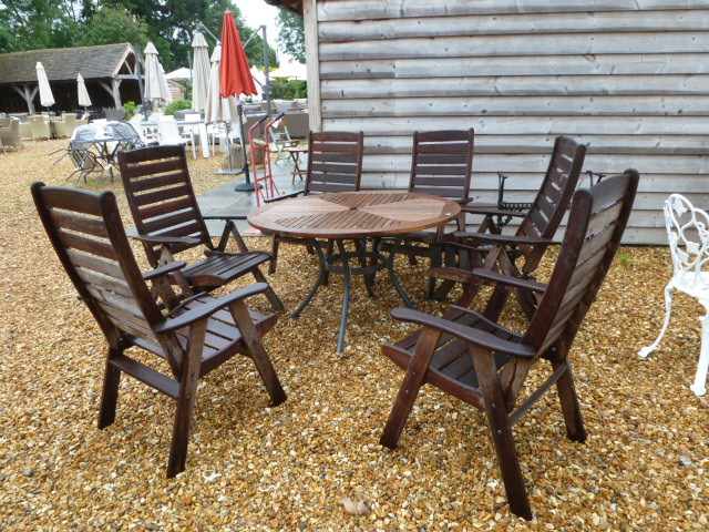 A second hand teak garden table with six armchairs,