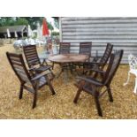 A second hand teak garden table with six armchairs,