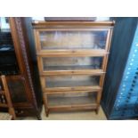 A mahogany four tier Globe Wernicke bookcase - one section with the Globe Wernicke label - 141cm x