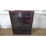 A Victorian mahogany glazed cabinet bookcase/shop fitting with sliding doors - Height 138cm x 112cm