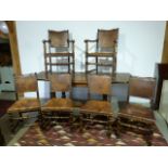 An oak refectory draw leaf table and eight leather seated chairs including two carvers - Height