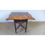 A George III mahogany butterfly Pembroke table with single frieze drawer on canted square supports