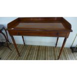 An early 19th century mahogany sidetable with a gallery and single frieze drawer on ring turned