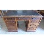 A 19th century mahogany kneehole desk with eight active drawers and a secret base compartment -