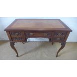 A walnut writing table with a leather inset top and five drawers on carved cabriole legs - Height