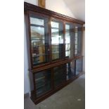 A late Victorian/Edwardian shop display cabinet with a glazed four door top above a glazed four
