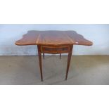 A 19th century mahogany butterfly Pembroke table with satinwood banding,