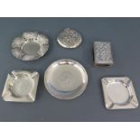 An Iranian silver ashtray set with a coin and two Dutch silver ashtrays (one coin inset) and a