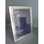 A silver photo frame Richard Carrs - 21cm x 16cm - good condition