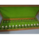 A boxed set of 12 silver spoons in a wooden presentation box for The Royal Horticultural Society