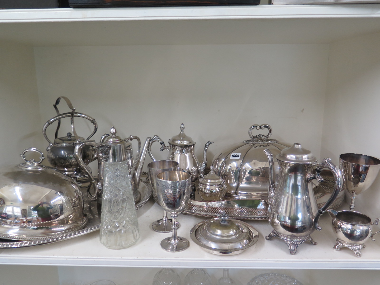 A quantity of silver plate including a claret jug, two meat covers, two trays,