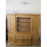 A good quality modern oak breakfront dresser/library bookcase unit with a one piece top having two