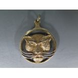 A silver gilt hallmarked hinged magnifying glass with large cat head motif to one part,