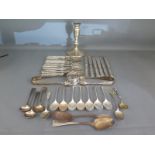 Six silver handled knives, eleven silver handled forks, a small silver hallmarked candlestick,