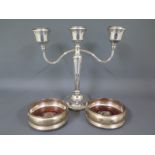 A pair of silver hallmarked coasters and a three branch candelabra