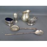 A small silver milk jug, a blue glass lined silver salt and mustard both with spoons,