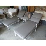 A pair of Bramblecrest Portofino lounger with cushions and coffee table