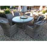 A Bramblecrest Sahara 212cm oval table with six deluxe armchairs,