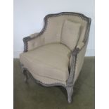 A modern armchair with a painted frame and beige upholstery - as new