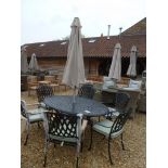 A Bramblecrest Rome table withy six chairs and cushions with parasol and base