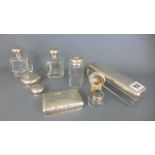 A collection of five silver top bottles including an inkwell and three silver bottle tops - total