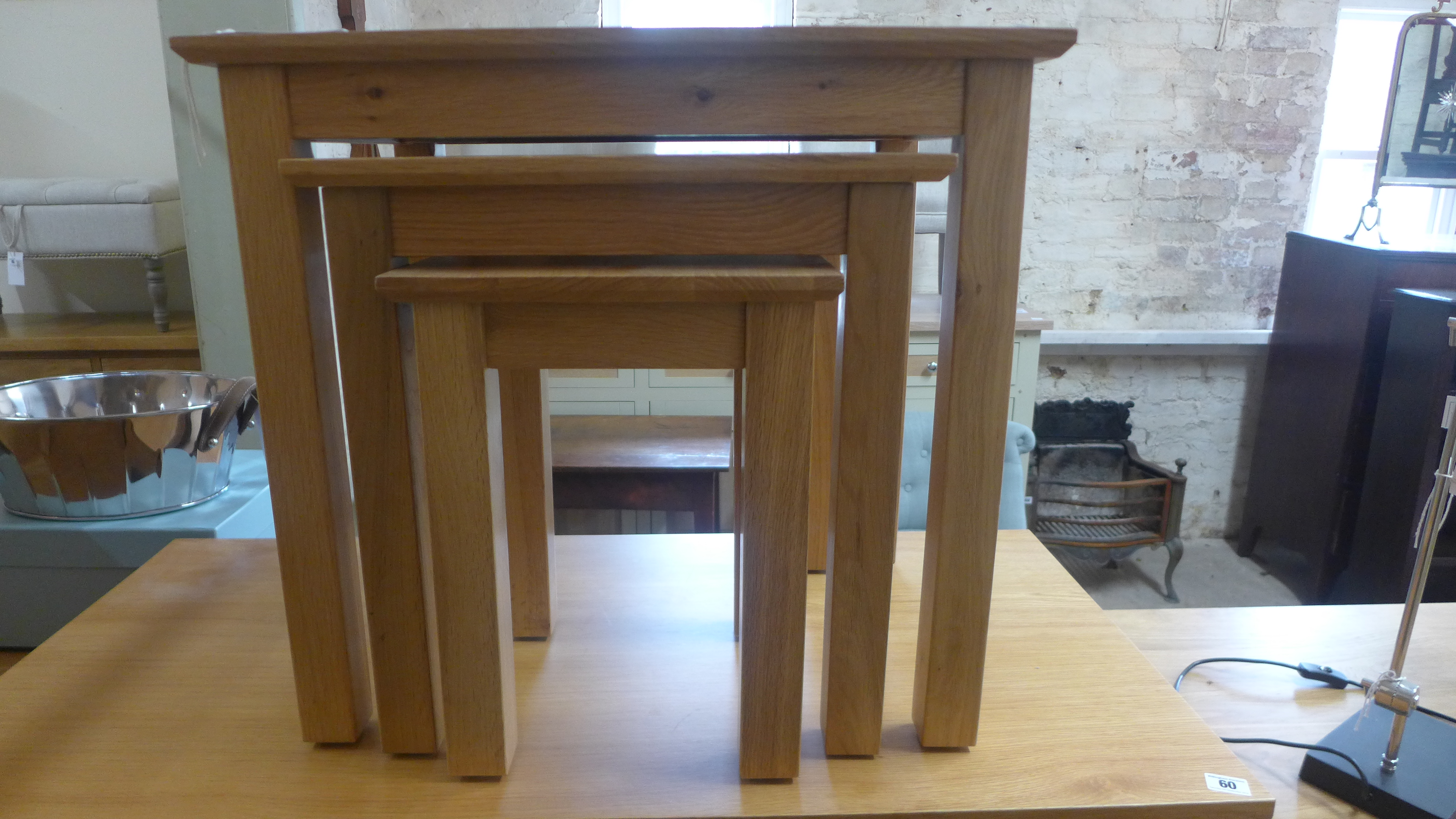 A nest of three oak tables