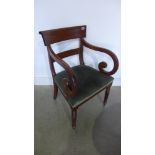 A 19th century mahogany scroll arm carver chair