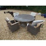 A Bramblecrest round concrete table with four Rio chairs