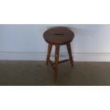 A Victorian oak three legged stool