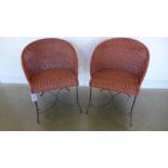 A pair of modern caned wrought metal chairs