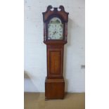 An 8 day oak and mahogany longcase clock with a painted arched 12" dial signed Jus Peters Cambridge